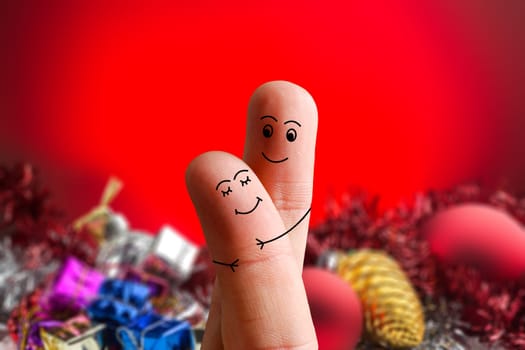 Faces of fingers hugging each other isolated on Christmas decorated background. Happy family celebrating Christmas day concept