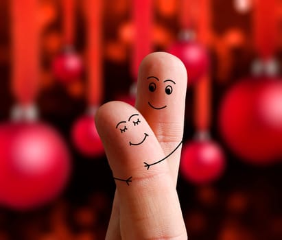 Faces of fingers hugging each other isolated on Christmas decorated background. Happy family celebrating Christmas day concept