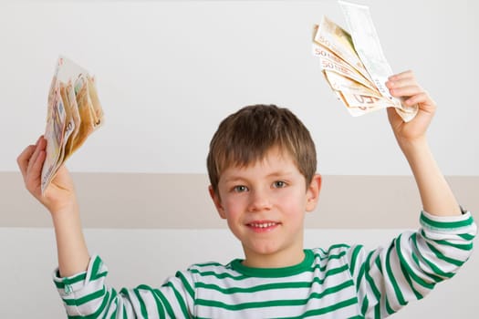 Cheering boy with banknotes in hand