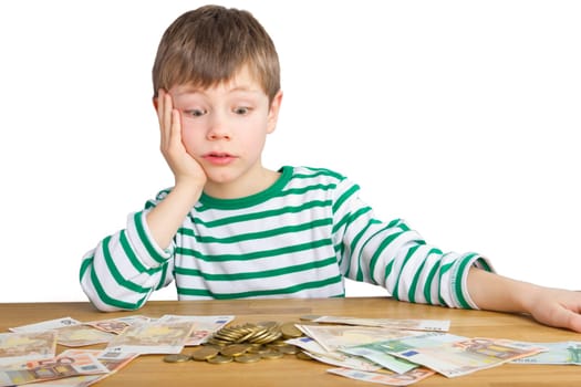 Boy sits in amazement in front of coins and bills