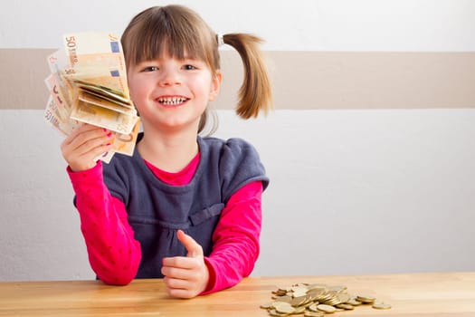 Child is happy about a lot of money