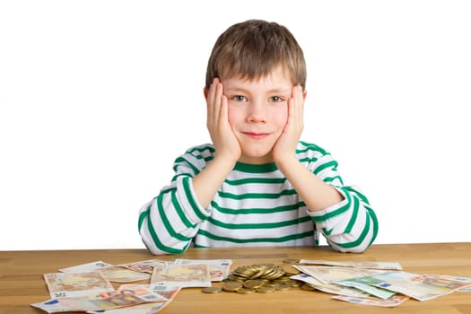 Boy sitting in front of coins and bills