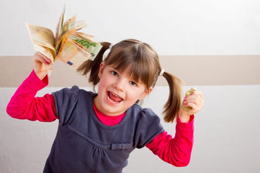 Cheering girl with money in her hands