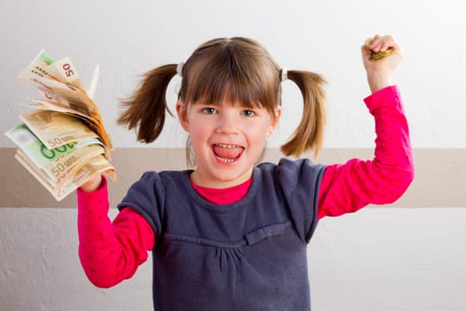 Cheering girl with money in her hands