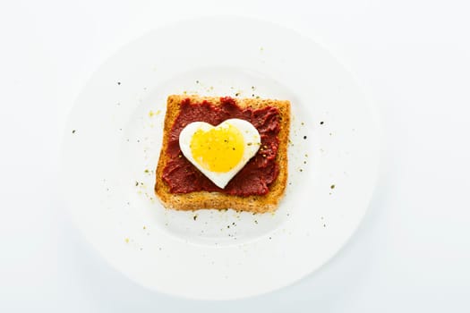 Fried egg heart on toast