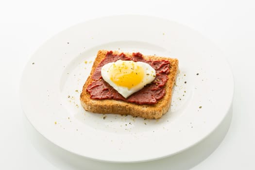 Fried egg heart on toast