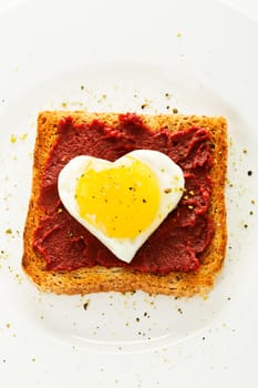 Fried egg heart on toast