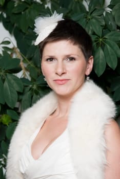 Portrait of a bride with headdress in white dress and fur