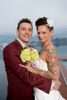 Upper body shot frontally from the front of a bride and groom