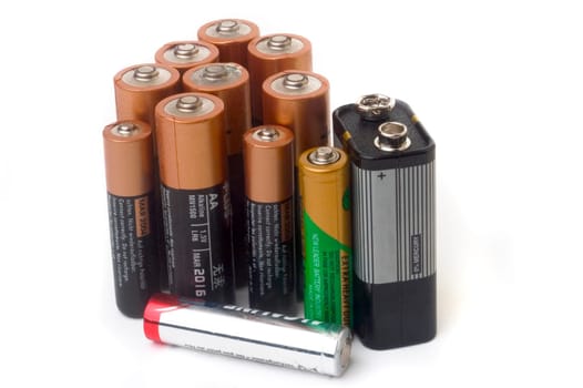 batteries of various forms and power on white zone in studio