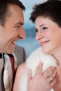 Bride and groom laugh at each other