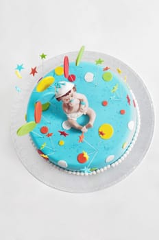 Studio shot of blue birthday cake on light background
