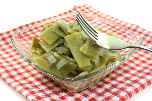 a bowl of bean salad against a white background
