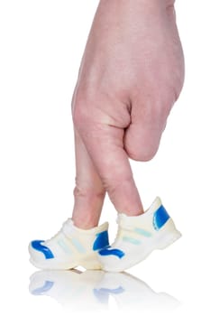 Fingers  wearing sports trainers and walking on white background