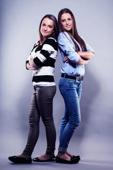 Two Female Pretty Teens Stand Back To Back