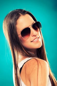 Pretty young girl in sunglasses looking over her shoulder