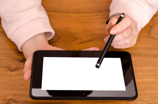 Two hands of a woman with tablet computer and touch pen