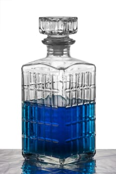 A crystal carafe filled with blue liquid