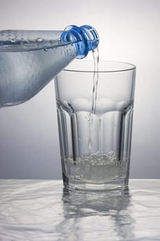 Pouring sparkling water into a caipirinha glass