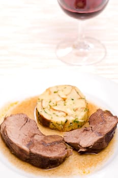 Braised roast of wild boar with napkin dumplings and red wine