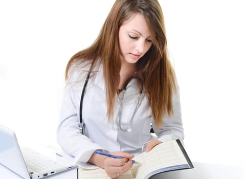 Pretty female doctor isolated writing in a Planner