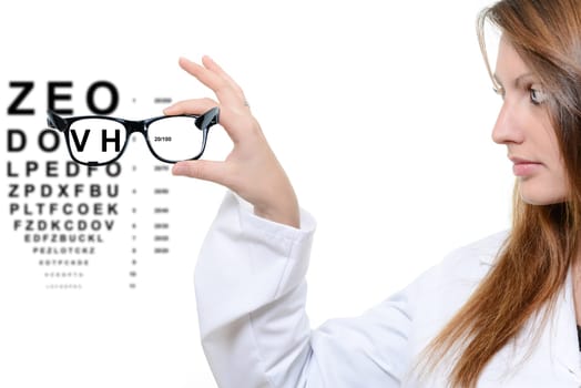 Woman with glasses and snellen eye chart in background