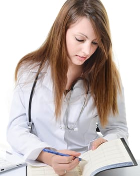 Pretty female doctor isolated writing in a Planner