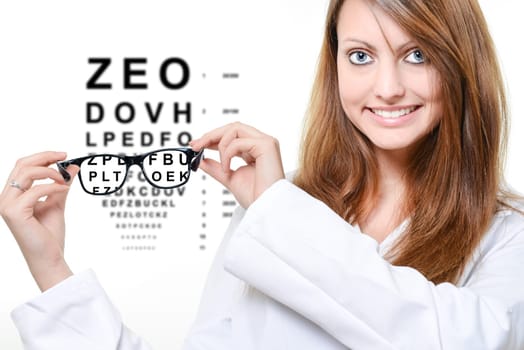 Woman with glasses and snellen eye chart in background