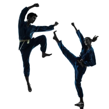 one caucasian man woman couple exercising karate vietvodao martial arts in silhouette studio isolated on white background