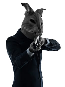 one caucasian man rabbit mask hunting with shotgun portrait in silhouette studio isolated on white background