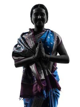 one indian woman saluting praying in silhouette studio isolated on white background