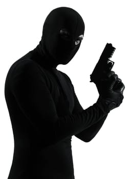 thief criminal terrorist holding gun portrait in silhouette studio isolated on white background