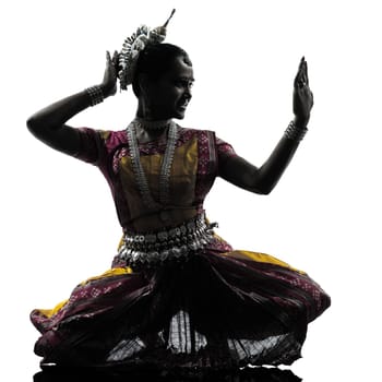 one indian woman dancer dancing in silhouette studio isolated on white background