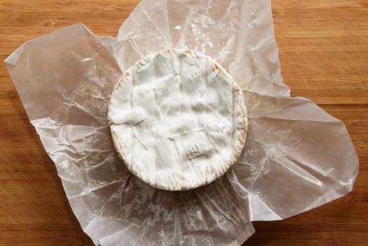 Camembert cheese on a wooden board