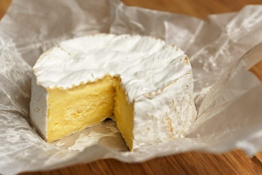 Camembert cheese on a wooden board