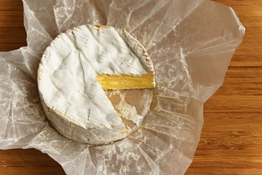 Camembert cheese on a wooden board