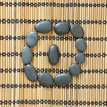 Details of a tranquil scene, made with black pebbles in a circle