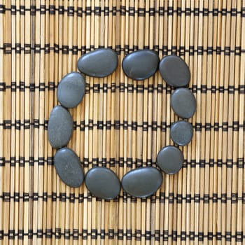 Details of a tranquil scene, made with black pebbles in a circle
