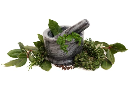 Marble pestle and mortar with herbs on white