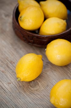 Fresh lemons on wooden surface