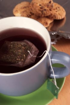 Cup of red tea with cookies