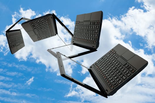 Cloud Computing - Flying Notebooks on Summer blue sky with clouds
