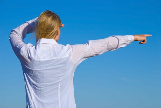 a person with white skirt showing something with her hand