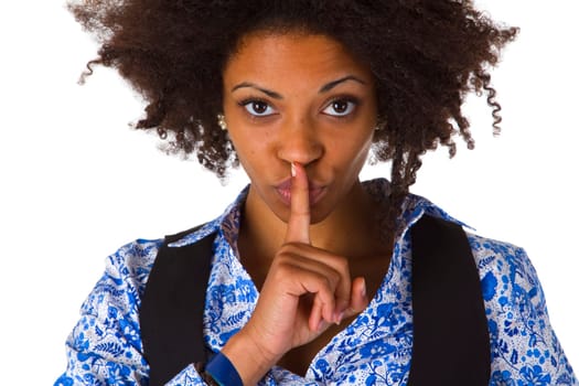 Young African-American woman holding index finger in front of her mouth - isolated on white background