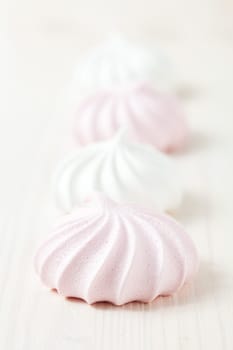 Row of meringues on light background