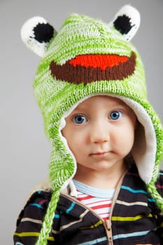 Portrait of a serious cute baby boy, studio shot.