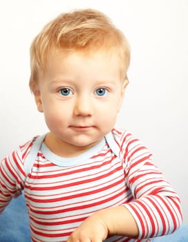 Studio portrait of a happy one year old baby boy.