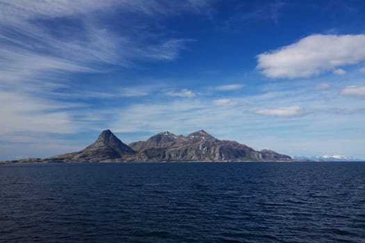 Lone rocky island in norwegian sea viewed from the sea