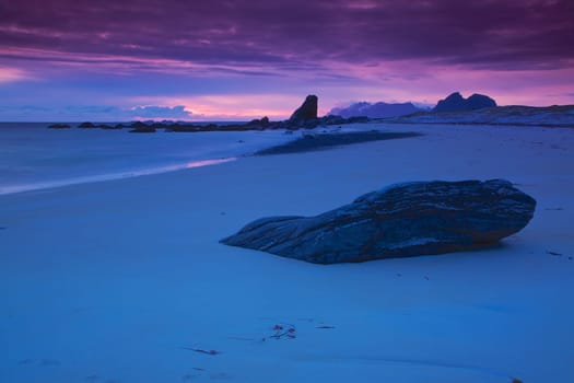 Scenic sandy beach lit by midnight sun on Lofoten islands in Norway