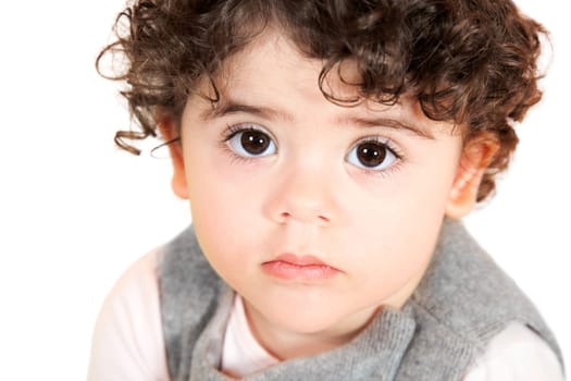 Two year old girl with curly hair portrait, studio shot.